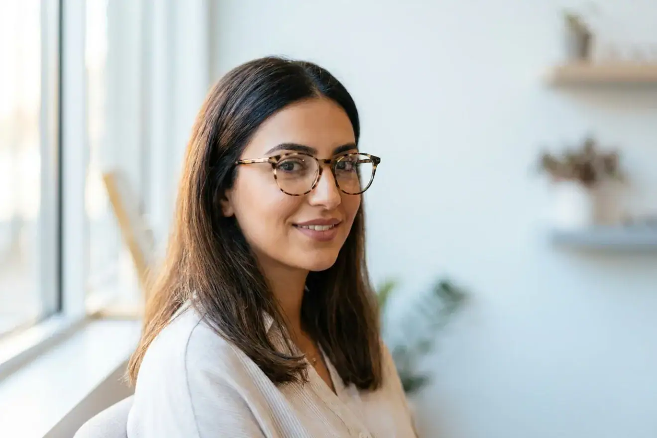 Woman wearing prescription glasses from Optic One Abu Dhabi